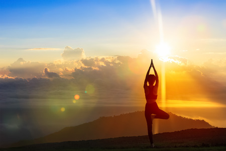 Young woman in a meditating yoga on the beautiful morning. healthy lifestyle.の写真素材