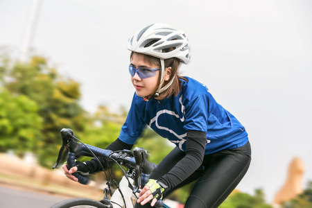 Asian woman cycling in the park. healthy conceptの写真素材