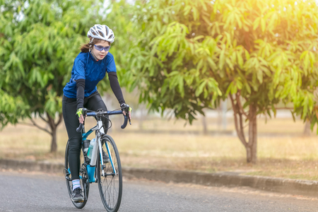 Asian woman cycling in the park. healthy conceptの写真素材