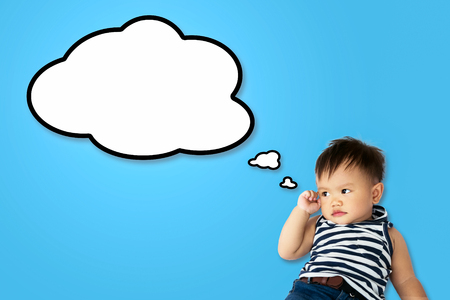 Baby boy thinking on white bed. copy space.の写真素材