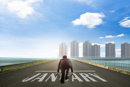 Business man ready to run toward the city on January. Business conceptの写真素材
