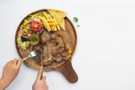 Tender grilled or t-bone steak served with French fries and herb salad. Top viewの写真素材