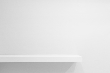 Empty white shop shelf, retail shelf on white vintage background.の写真素材