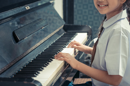 Asian Cute Girl Playing Piano At Home.の写真素材