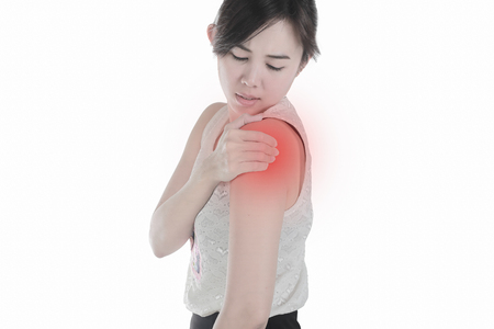 Young woman with shoulder pain isolated white background.の写真素材