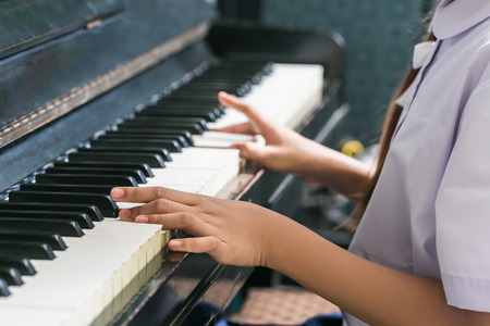 Asian Cute Girl Playing Piano At Home.の写真素材