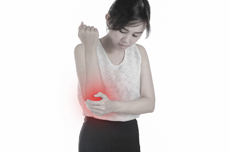 Woman with elbow feeling pain on white background.の写真素材