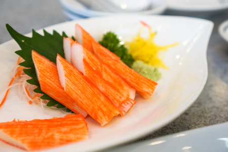 Crab sticks in a white dishl placed on a table.の写真素材