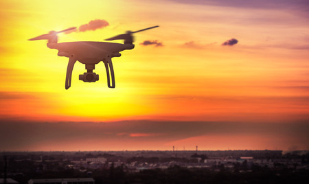 Drone in the sky at sunset. over the evening city.の写真素材