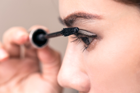 Closeup Of Asia Woman Beauty Makeup, Fresh Soft Skin And Long Black Eyelashes with Cosmetic brush.の写真素材