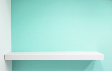 Empty white shop shelf, retail shelf on blue sky vintage background.の写真素材