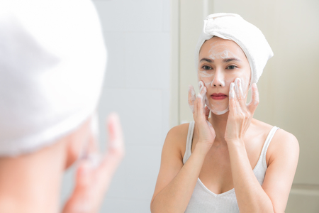 Asian woman cleaning face skin enjoy herself with bubble cleansing foam.の写真素材