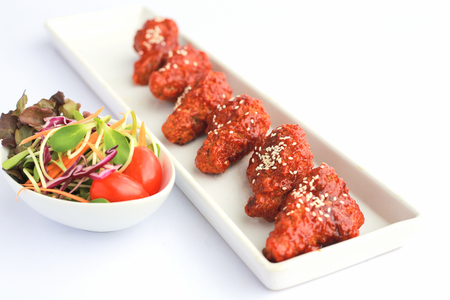 Bonchon Chicken spicy and sweet taste on white table.の写真素材