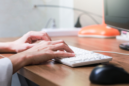 Working at home with pc woman writing a blog. Female hands on the keyboardの写真素材