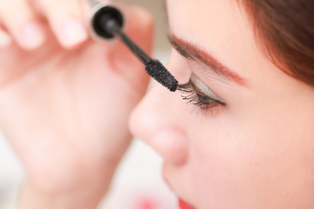 Closeup Of Asia Woman Beauty Makeup, Fresh Soft Skin And Long Black Eyelashes with Cosmetic brush.の写真素材
