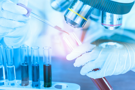 Female medical or scientific researcher using test tube on laboratory.の写真素材