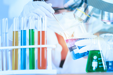 Young Scientist looking at test tube in the laboratory.の写真素材