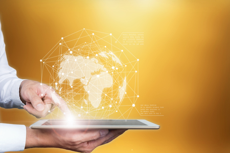 Business holding tablet touching screen world map.の写真素材