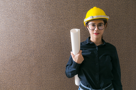 Business woman engineer developer holding blueprint on background.の写真素材