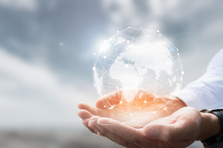Businessman holding in hand with global connection concept.の写真素材