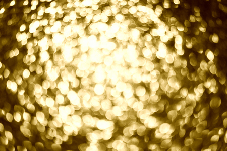 Abstract blurry gold bokeh lights defocused.の写真素材