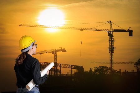 Engineers woman at construction site on background.の写真素材
