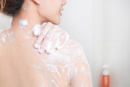 Woman taking a shower enjoying with foam bath.の写真素材