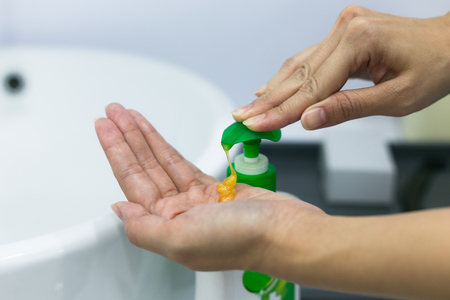 Hand of woman that applying alcohol gel to make cleaning bacteria. Health care.の写真素材