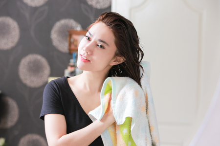 Beautiful Young Female After Bath Applying Hair Oil.の写真素材