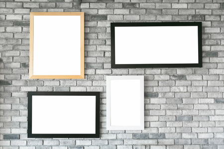 Different size and style empty photo frames on white concrete wall. with clipping pathの写真素材