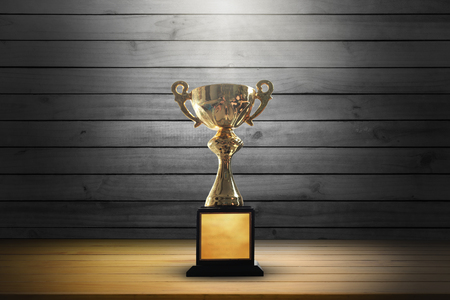 Champion golden trophy on wooden table background. copy space.の写真素材