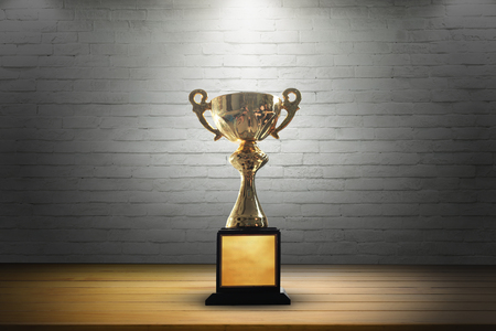 Champion golden trophy on wooden table background. copy space.の写真素材