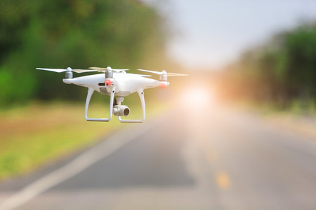 Drone copter flying with digital camera in the park.の写真素材