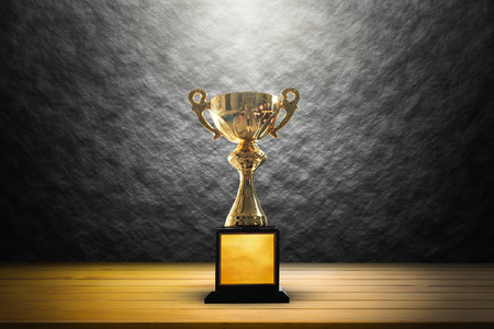 Champion golden trophy on wooden table background. copy space.の写真素材