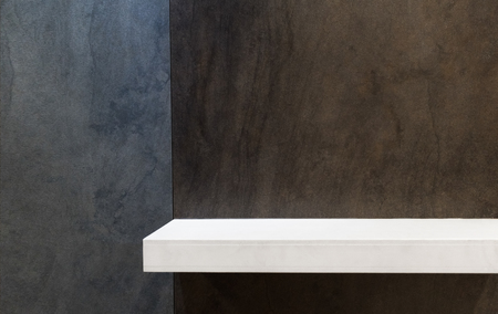White empty shelf on brown and grey ceramic wall.の写真素材