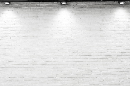 Empty white wall with halogen with lamps.の写真素材