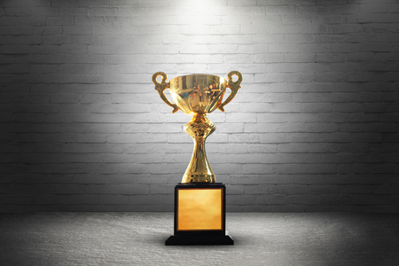 Champion golden trophy on wooden table background. copy space.の写真素材