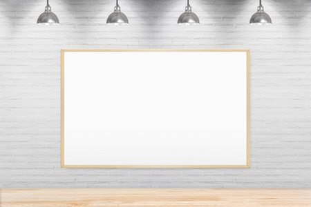 Blank chalkboard on brick wall in room with wooden floor with lamps.の写真素材