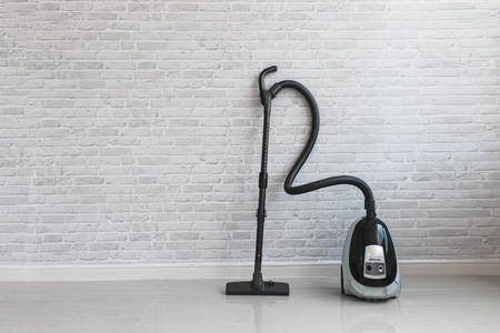 Vacuum cleaner on white concrete background in the house.の写真素材