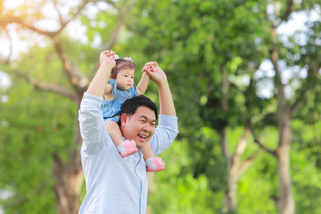 Father and son walking on the field at the garden. Concept of family.の写真素材