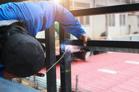 Industrial Worker labourer at the home welding steel balcony.の写真素材