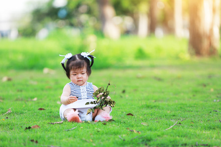 Cute Little Girl Playing Gardener with Flower.の写真素材
