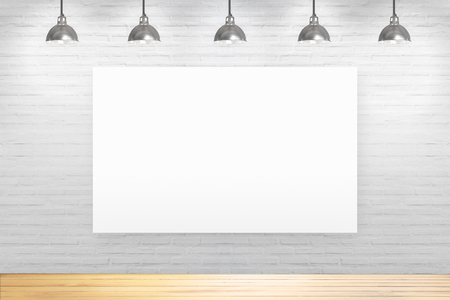 White brick wall in room with wooden floor with lamps.の写真素材