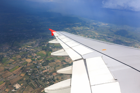 Wing of the airplane country land. travel conceptの写真素材