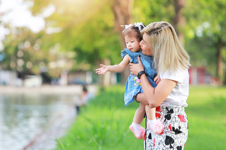 Beautiful mother and little daughter outdoors. Happy Mother's Dayの写真素材