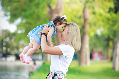 Beautiful mother and little daughter outdoors. Happy Mother's Dayの写真素材
