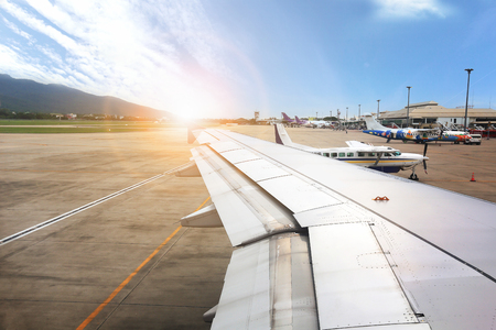 NAKHONRATCHASIMA, THAILAND - MAY 18, 2018 : Sunrise view the airport on ground from the inside airplane.のeditorial素材