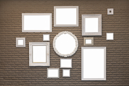 Photo of blank picture frames on white wall.の写真素材
