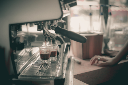 Espresso shot from coffee machine in coffee shop.の写真素材