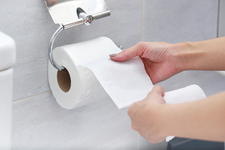 Close-up of Hand Using Toilet Paper.の写真素材